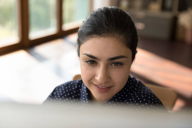 istock Happy millennial Indian woman working on computer. 1351342899