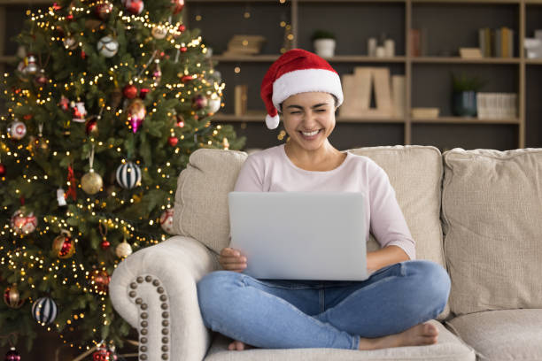 istock Happy millennial Indian woman using computer at New Year holidays. 1351343397