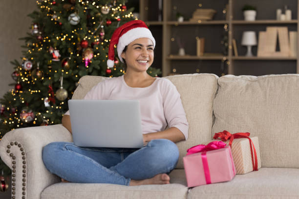 istock Happy young Indian woman using computer at home. 1351343454