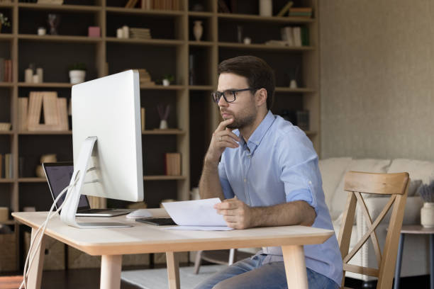 istock Concentrated smart 30s young male manager working in modern office. 1351343613