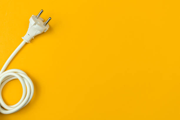 istock Electrical power cable with EU plug on a flat orange background, top view, copy space photo 1351344709