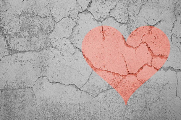 istock Red heart on a cracked wall texture, speration, divorce, betrayal, empty copy space 1351344757