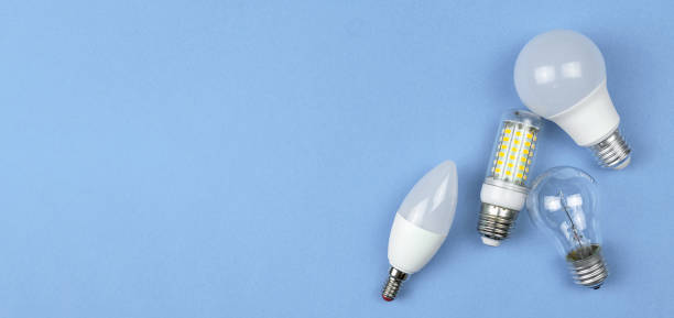 istock Different kinds of light bulbs, pastel blue background. Energy saving concept. Flat lay, top view, copy space photo 1351345826