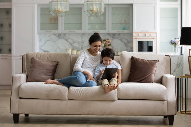 istock Happy young indian mother and little son using digital tablet. 1351347323