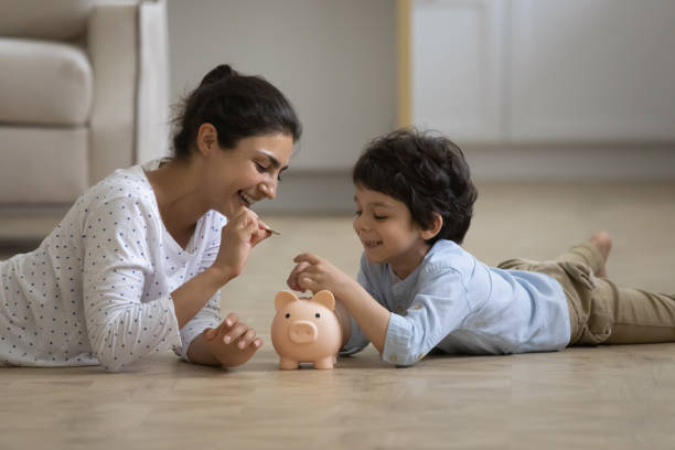 istock Young indian mother teaching small kid saving money. 1351347344