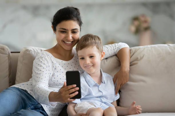 istock Happy mixed race family using funny mobile applications. 1351347362