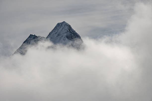 View of the Swiss mountains in winter. Eiger in clouds, Monoch and Jungfrau. Swiss alps in Jungfrauregion in Switzerland