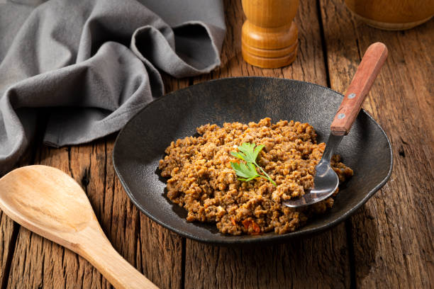 istock Ground beef in dark plate on the table. 1351353836