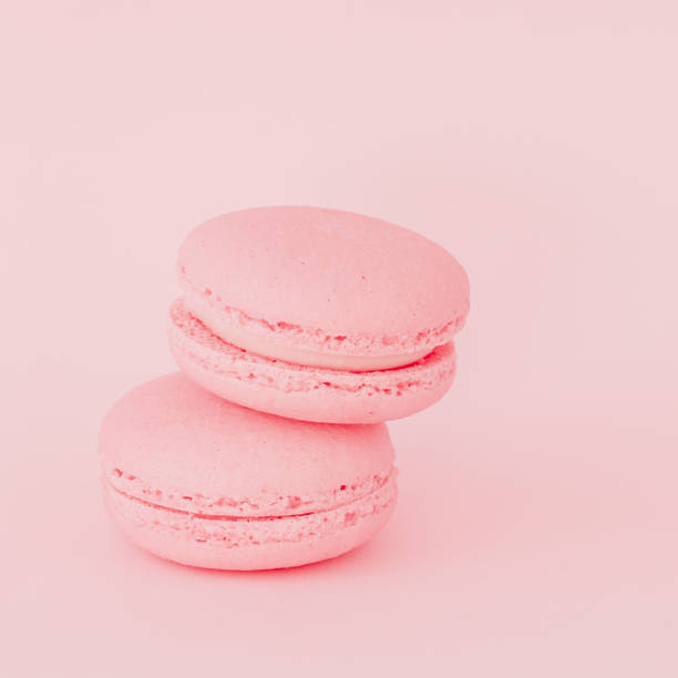 istock Gentle pink macaroons on pink background close-up 1351354759