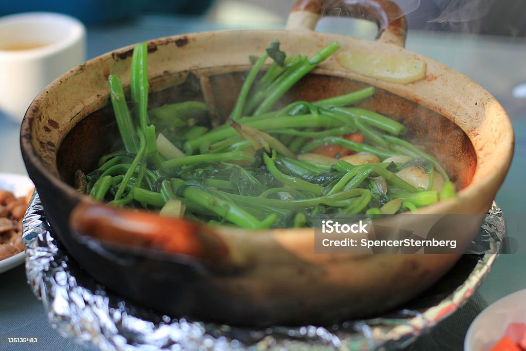 Misty Chinese Greens A clay pot of Chinese greens.  Chinese Food Stock Photo