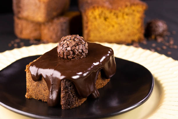 istock Carrot cake with chocolate cream and brigadeiro on a black plate 1351355763