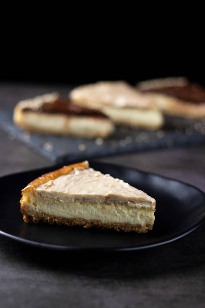 istock Cheesecake of white chocolate and peanut on a black plate 1351355798