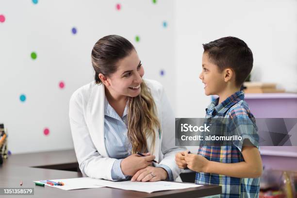 Happy Psychologist And Little Boy Smiling At Each Other Stock Photo - Download Image Now
