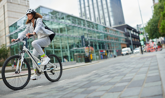 woman cycling through the city centre