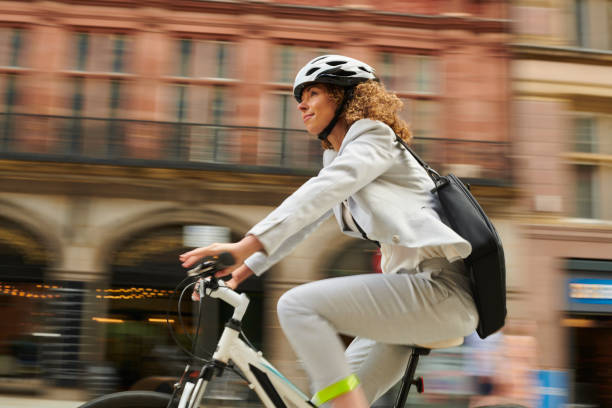 cycling commuter woman cycling through the city centre liverpool one stock pictures, royalty-free photos & images