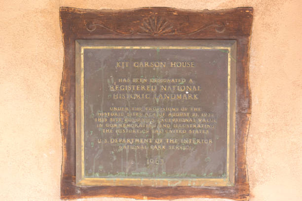Taos, NM: A bronze historic plaque on the Kit Carson house and museum in downtown Taos, NM.