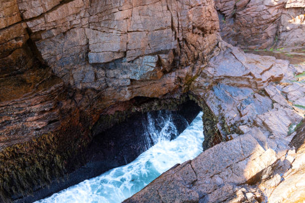 Wave crashing in the Thunder Hole in Acadia National Park in Maine.