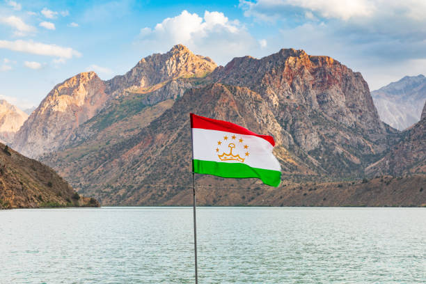 istock Tajik flag and mountain at Iskanderkul Lake. 1351367290