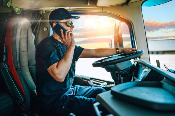 professional truck driver sitting in truck - telephone cabin imagens e fotografias de stock