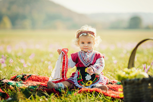 Cute baby girl in traditional Bulgarian costume.