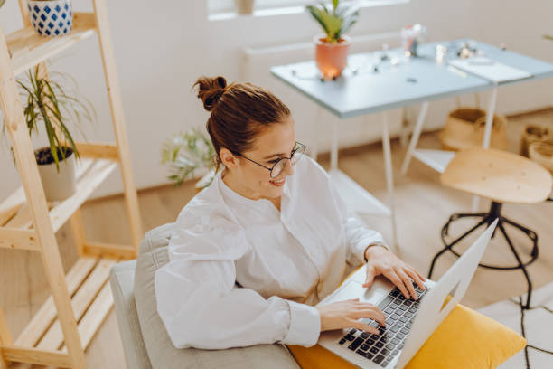 istock Happy young Woman in her Home Office and Using her Laptop 1351372196