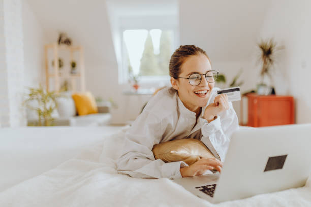 Happy young Woman in her Home Office and Using her Laptop stock photo