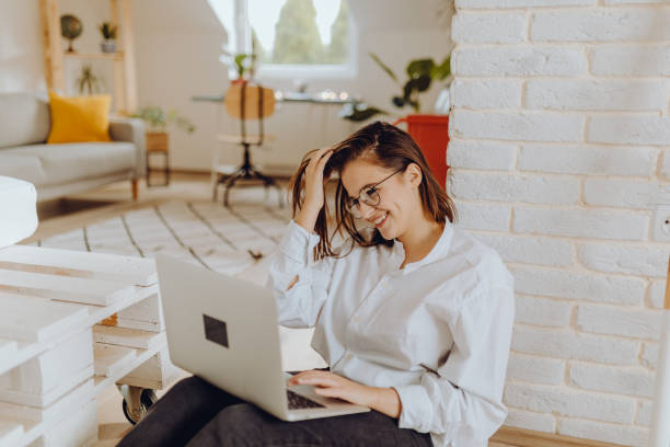 istock Happy young Woman in her Home Office and Using her Laptop 1351372253