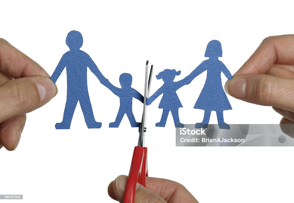 Paper chain family divorce Man and womans hands cutting paper chain family concept for divorce and child custody battle Paper Chain Stock Photo