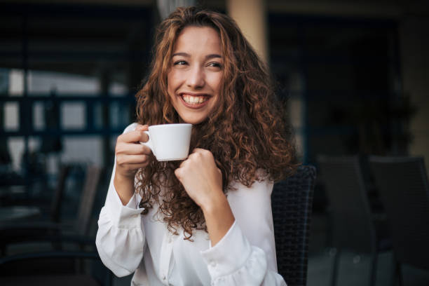 istock woman enjoying cappuccino in a cafe 1351374274