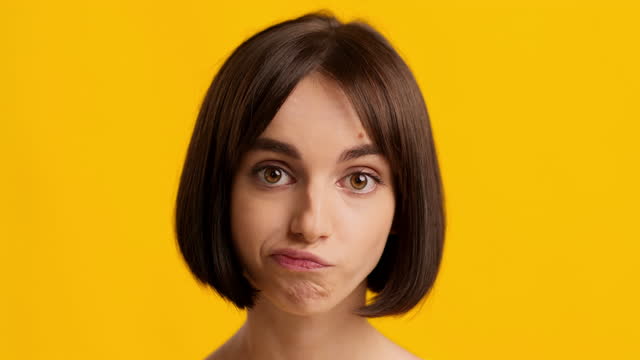 Bored Millennial Female Rolling Eyes Posing Over Yellow Background