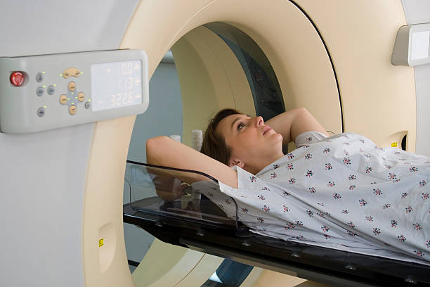 istock Woman lying down ready for a MRI scan 135137502