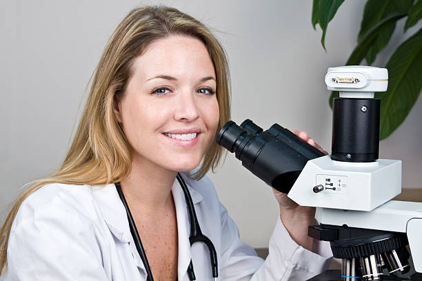 istock Woman Doing Medical Research Looking Through a Microscope 135137741