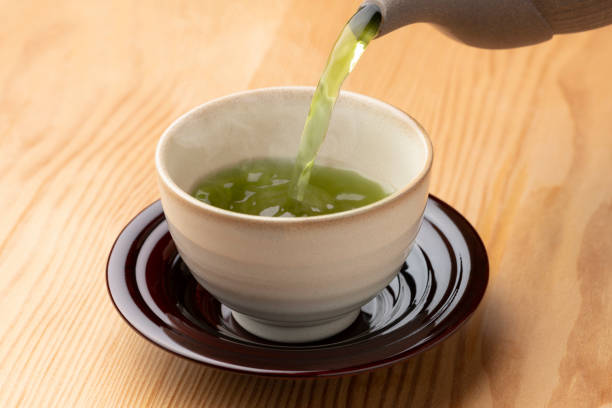 istock Warm green tea on a wooden table. 1351381177
