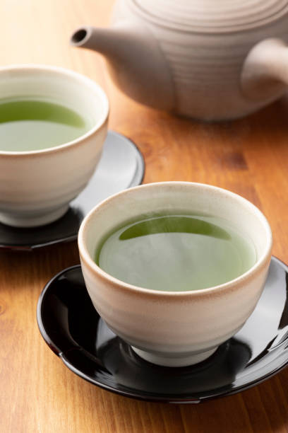istock Warm green tea on a wooden table. 1351381180