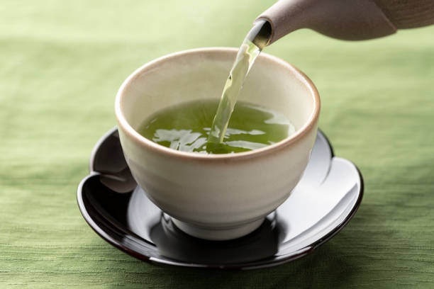 istock Warm green tea on a wooden table. 1351381200