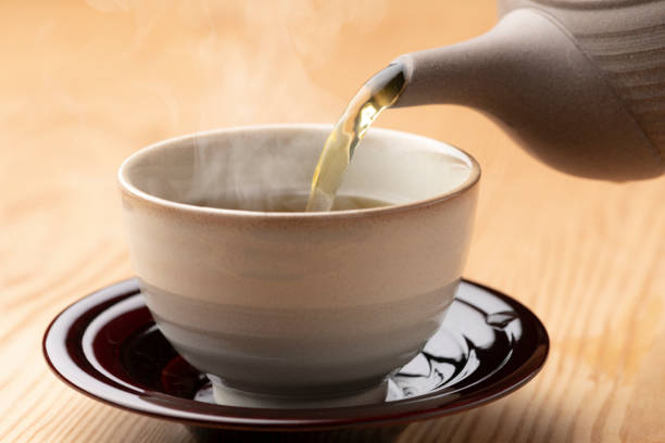 istock Warm green tea on a wooden table. 1351381204