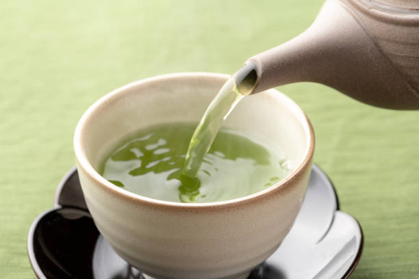 istock Warm green tea on a wooden table. 1351381207