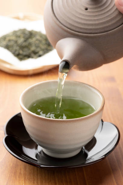 istock Warm green tea on a wooden table. 1351381216