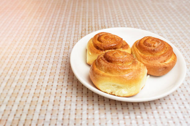 homemade buns on a white plate on the table.