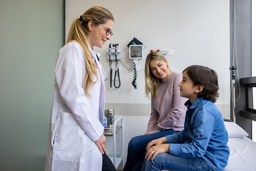 Young patient talking to a doctor at her practice