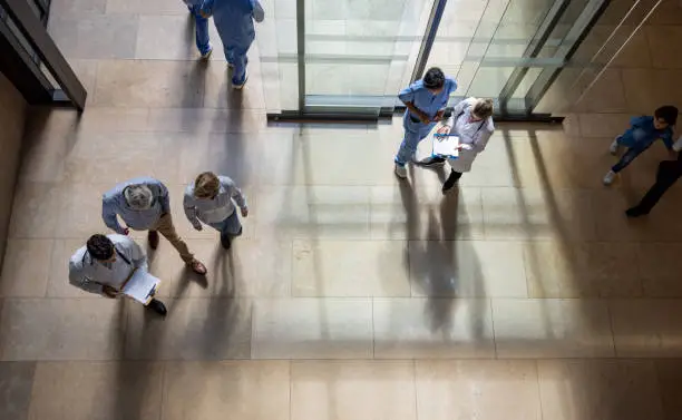 Latin American patients and doctors coming in and out of the hospital - healthcare and medicine concepts