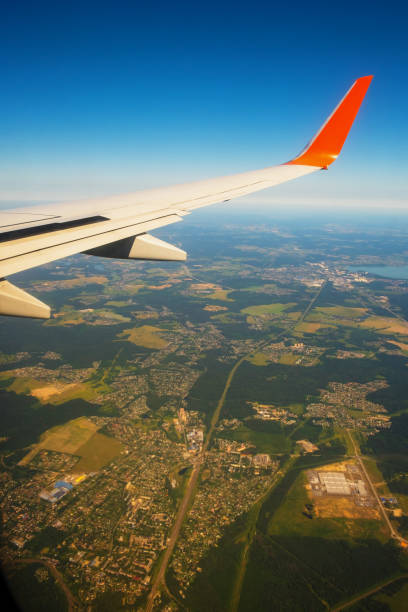 istock Classic image through aircraft window onto wing. Flight view over Russia 1351400384