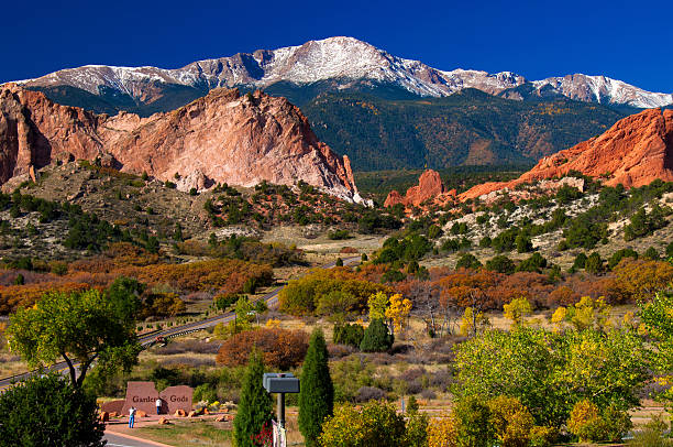 Garden of the Gods in Autumn 2011 Garden of the Gods Park in Autumn 2011 with Pikes Peak, located near Colorado Springs. Notice the tiny tourists taking a picture at the stone sign. colorado springs stock pictures, royalty-free photos & images