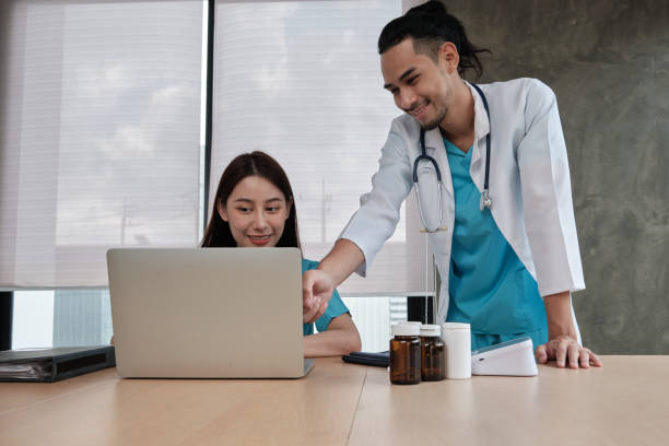 istock Two uniformed young doctors work in medical clinic office. 1351405828