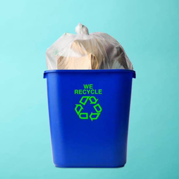 istock Blue plastic recycle bin with garbage bag on on light blue background 1351407724