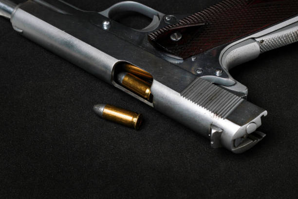 istock Automatic white gun stainless steel pistol weapon with real bullet ammo head in black background 1351408758
