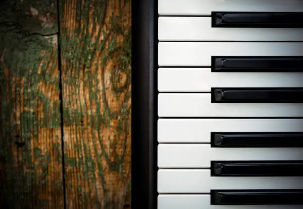 Piano Keyboard on the Old Wooden Planks Background closeup