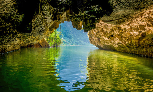 Boat cave tour in Trang An Scenic Landscape. Trang An is UNESCO World Heritage Site. It's Halong Bay on land Ninh Binh province, Vietnam. Travel and landscape concept.