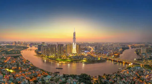 aerial view of Ho Chi Minh city, Vietnam, beauty skyscrapers along river light smooth down urban development, a developed metropolitan with office and business center. Travel and business concept.