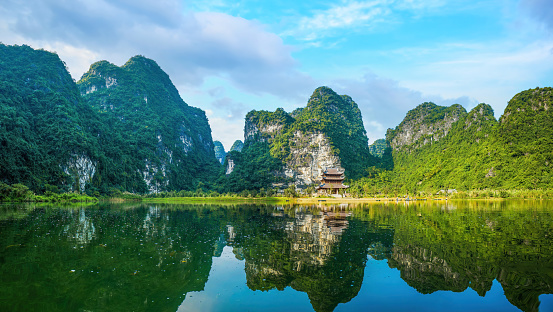 Boat cave tour in Trang An Scenic Landscape. Trang An is UNESCO World Heritage Site. It's Halong Bay on land Ninh Binh province, Vietnam. Travel and landscape concept.